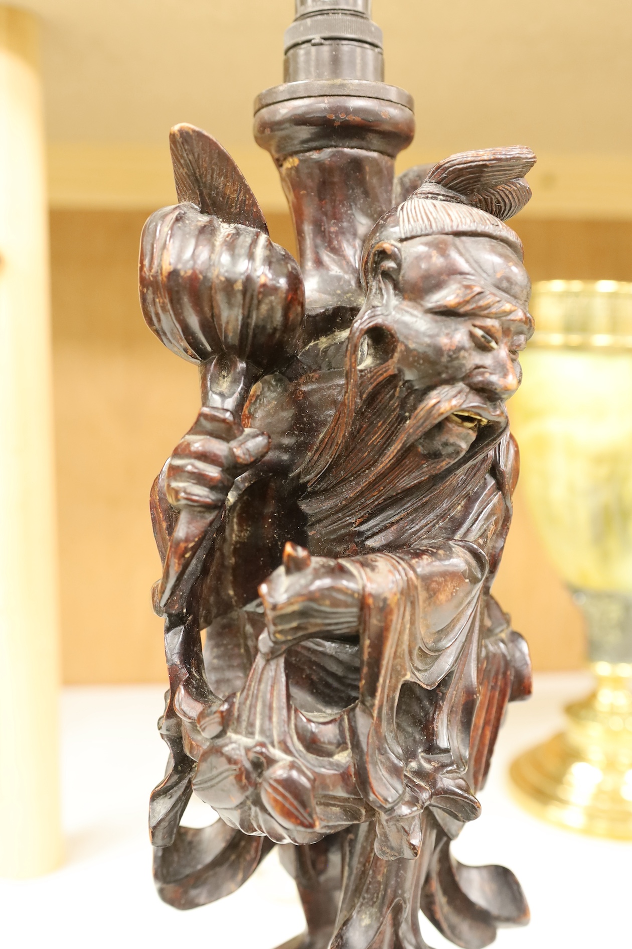 A Chinese carved wooden figural table lamp base, 36cm high not including light fitting. Condition - rubbed in places.